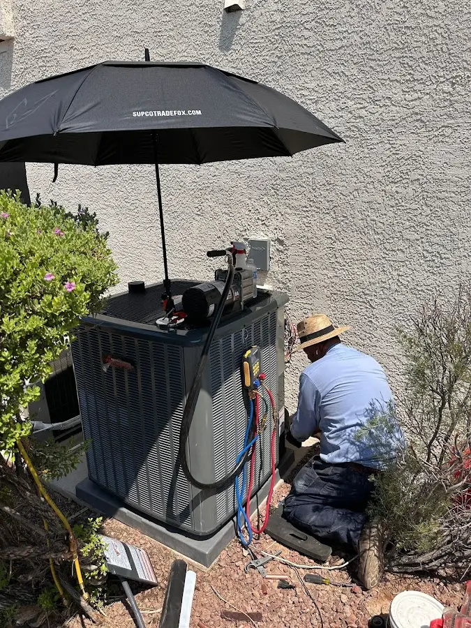 HVAC technician performing outdoor AC maintenance in Cicero